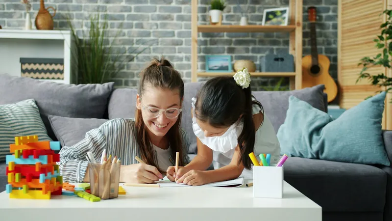 A mother and daughter coloring together at home