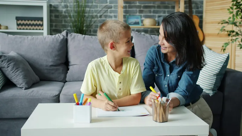 A mother helping her son with a worksheet